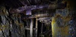 Still stranded in a water-filled mine, laborers and children